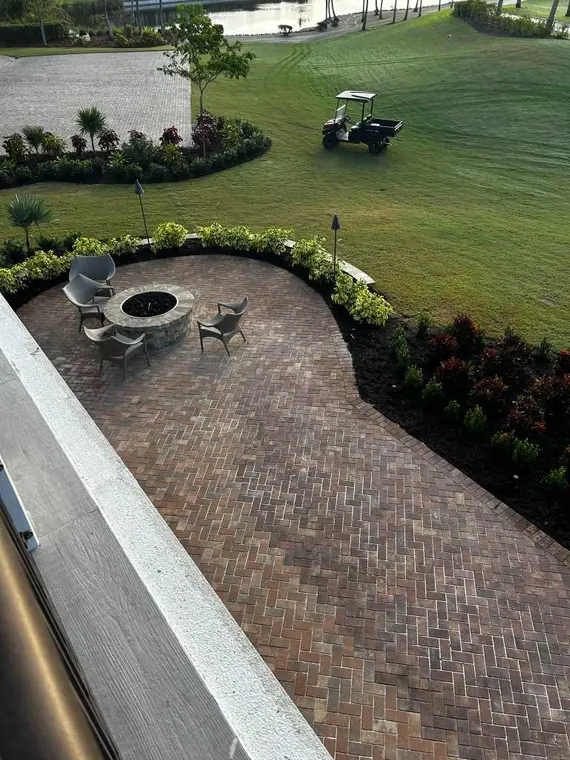 Elevated brick paver patio and landscaped retaining border