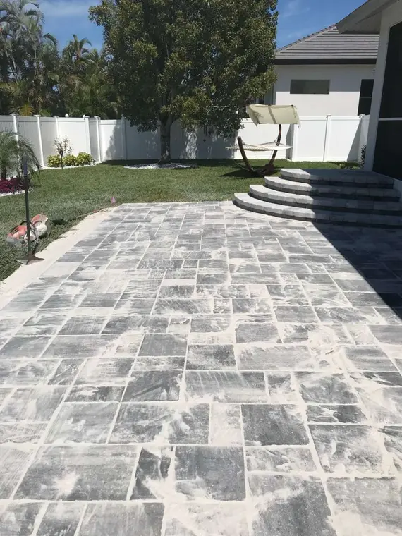 Gray paver entry with curved steps at a residence