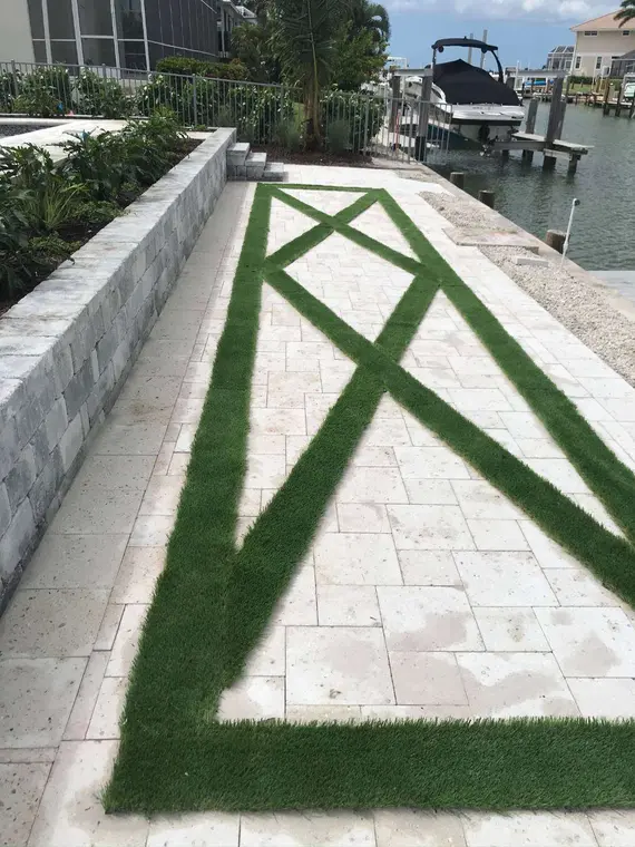 Modern light paver walkway with linear turf inlays