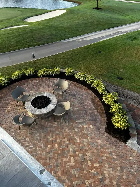 Round fire-pit area built into a brick paver patio